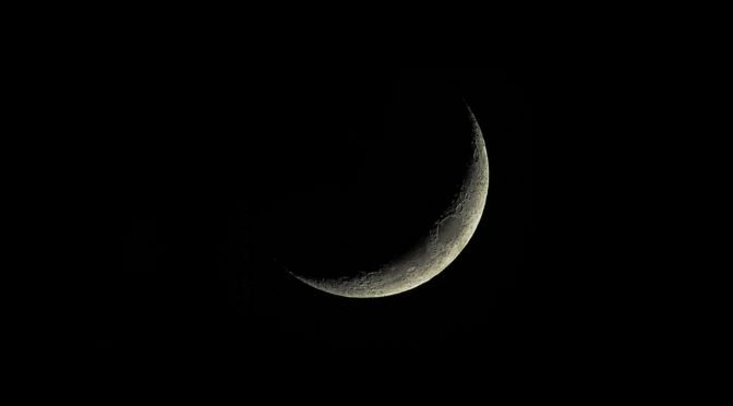 A crescent moon in the night sky, the sighting of which can be used to determine the dates for the Islamic months, such as Rajab