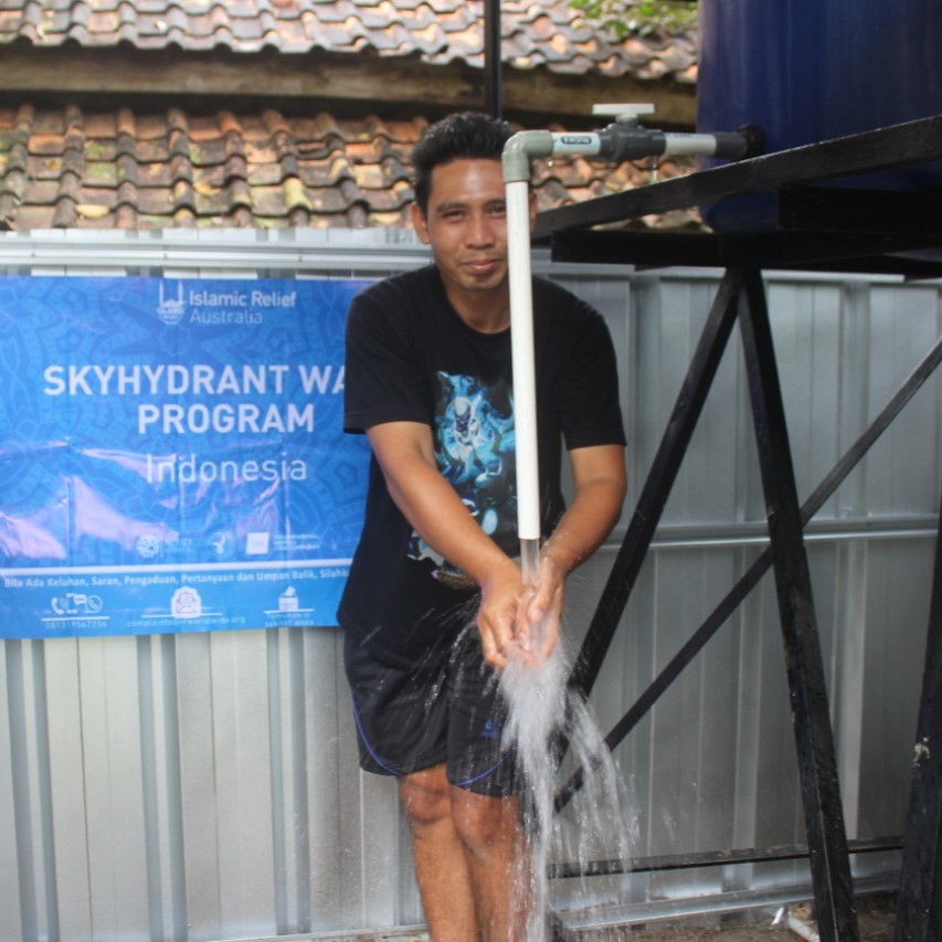 Male rightholder benefiting from water project in Indonesia
