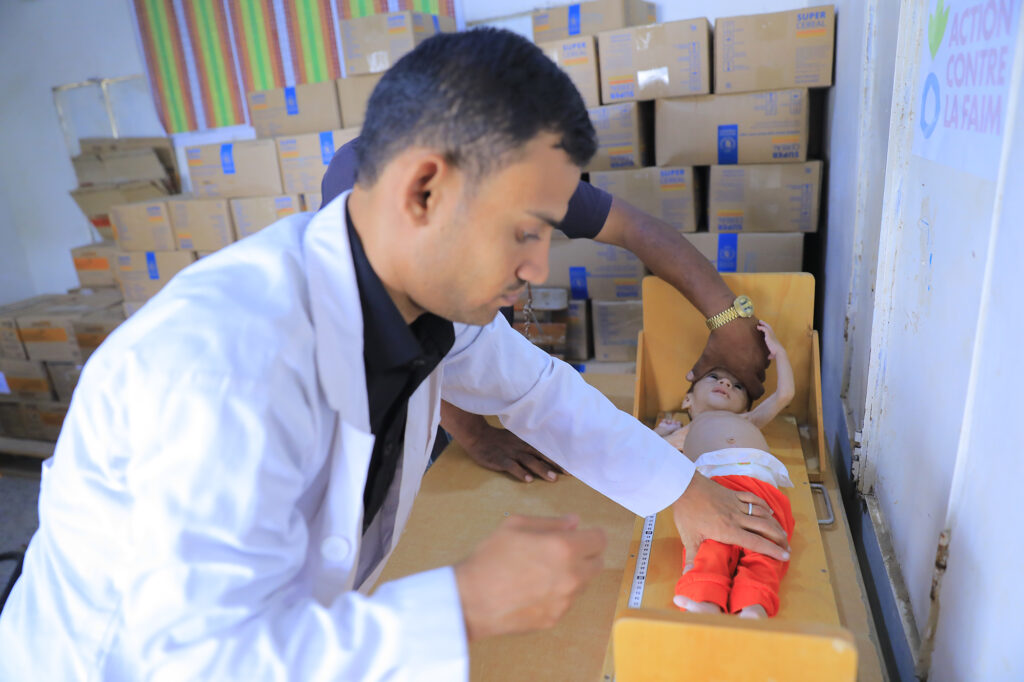 Saddam's son being measured by Islamic Relief staff in Yemen during medical check up