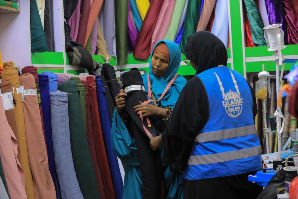 Kos, orphan Ahlam's mother, in her clothes and tailoring shop