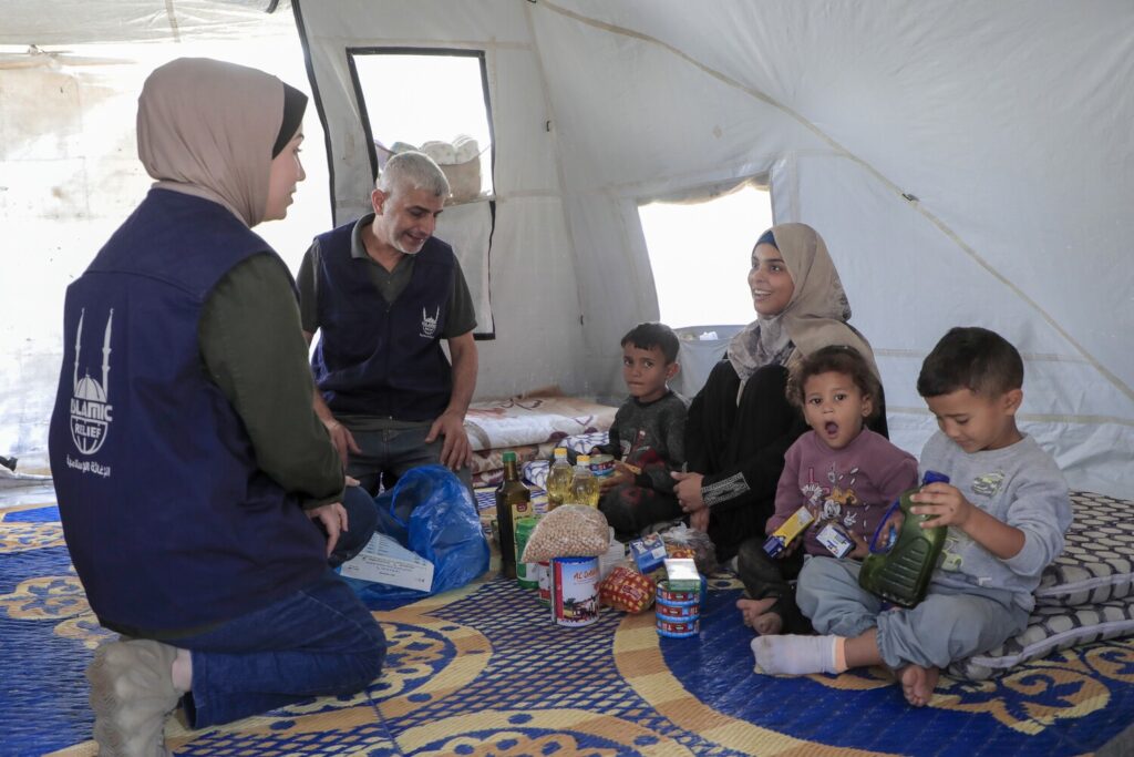 Islamic Relief staff in Gaza handing out aid to the needy (a displaced family) - one of the recipients of zakat