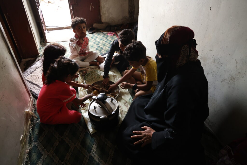 Saltanah's family in Yemen having a meal from the food provided by Islamic Relief